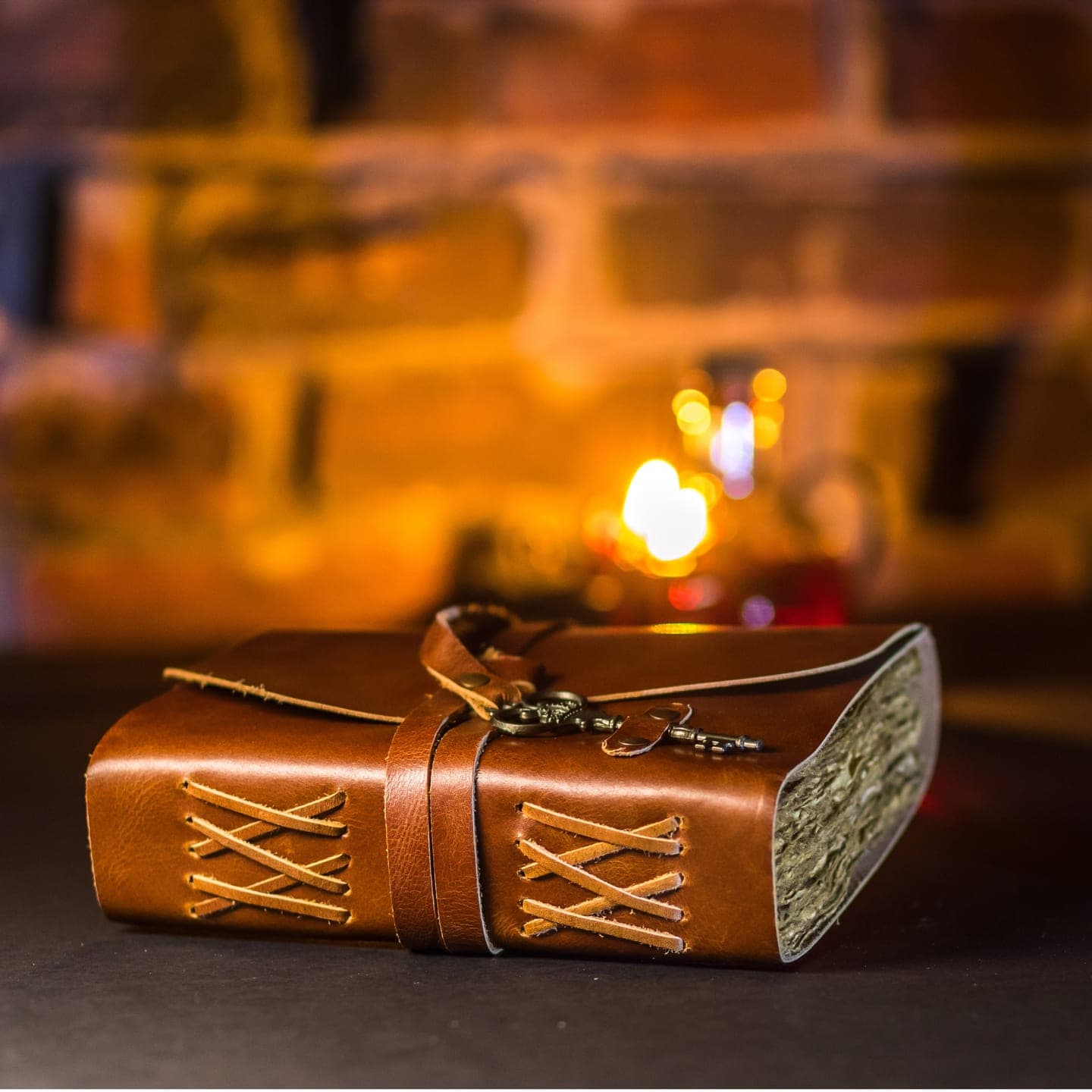A leather journal locked with an old key, in candlelight.